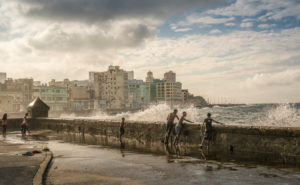 At the Malecon Havana, playing children, splashing surf, drops of water, Cuba At the Malecon Havana, playing children, splashing surf, drops of water, Cuba